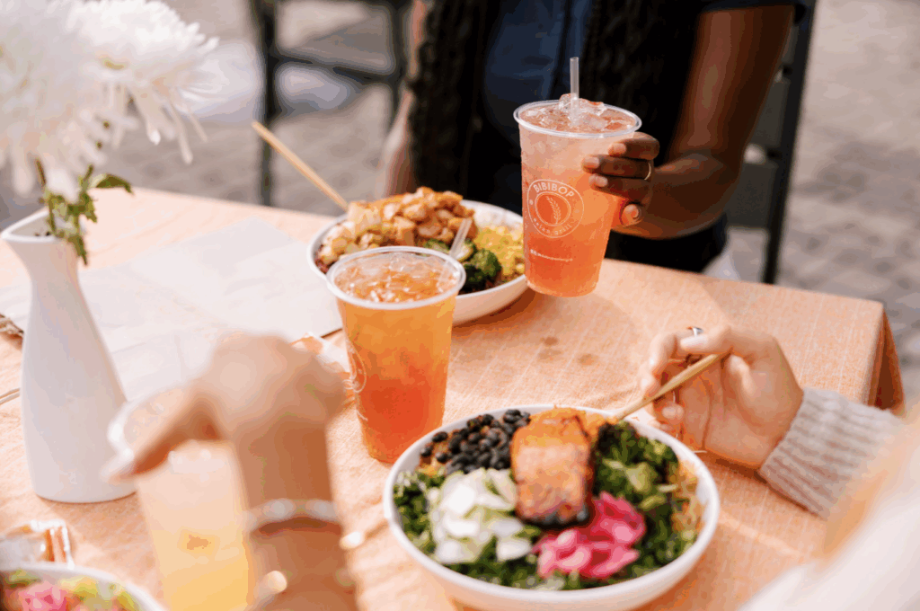 Healthy fast casual dinner at BIBIBOP with Chicken Bowl, Miso Glazed Salmon Bowl, and drinks