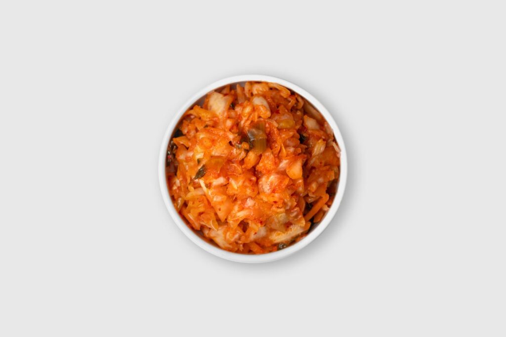 A small side dish of kimchi, served the traditional Korean way as banchan